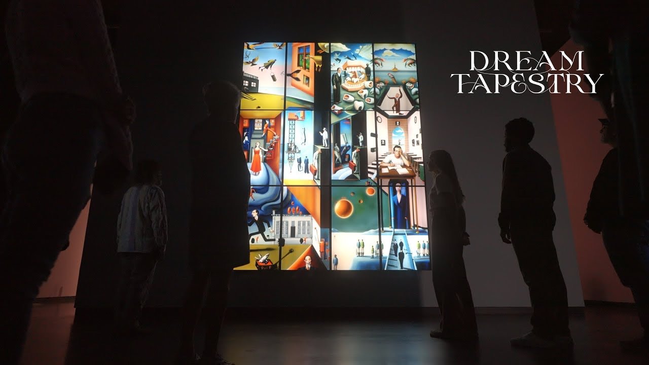 Visitors in front of the glowing 12-foot Dream Tapestry screen